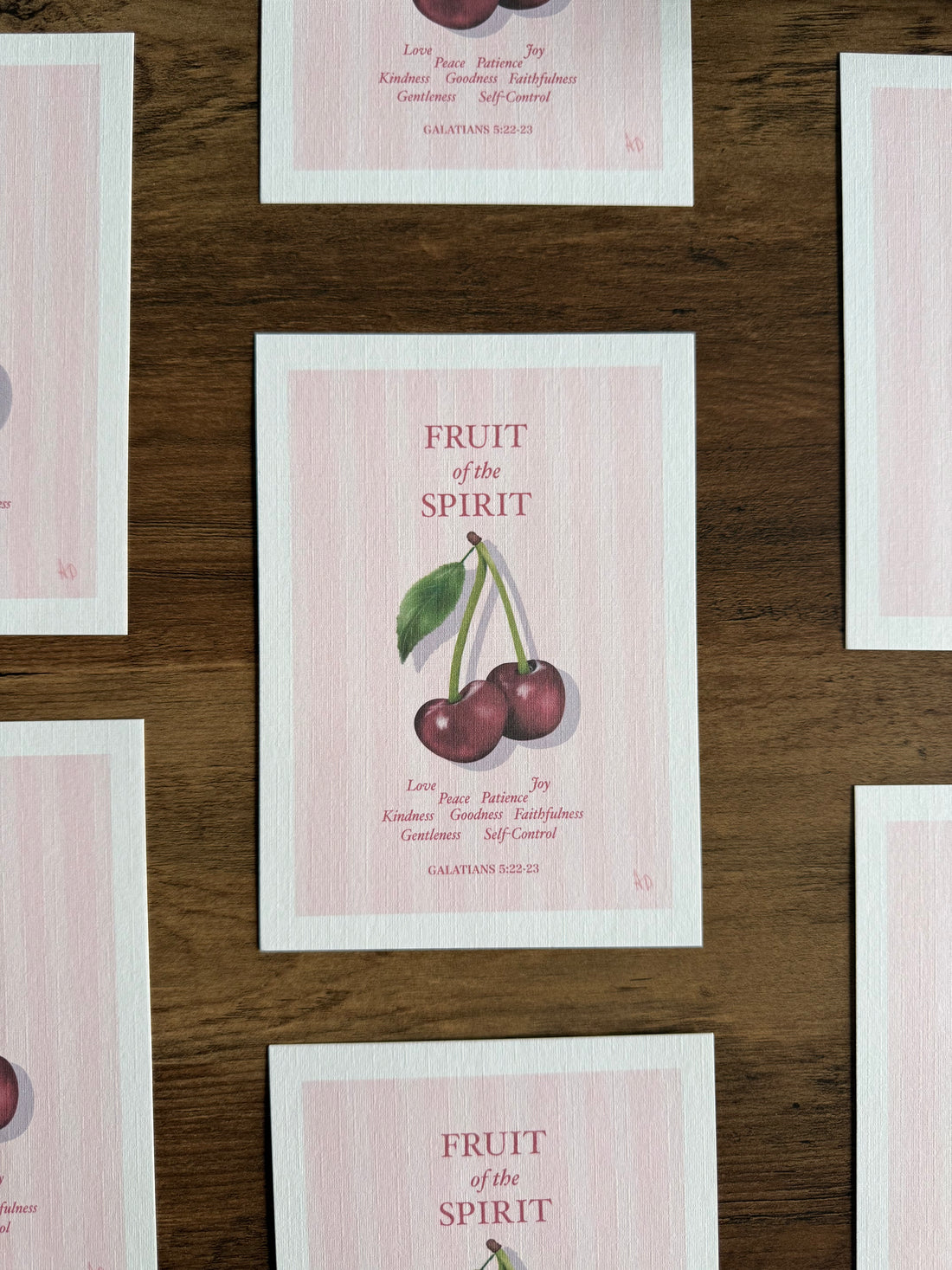 Fruit of the Spirit cards with cherries on a wooden surface