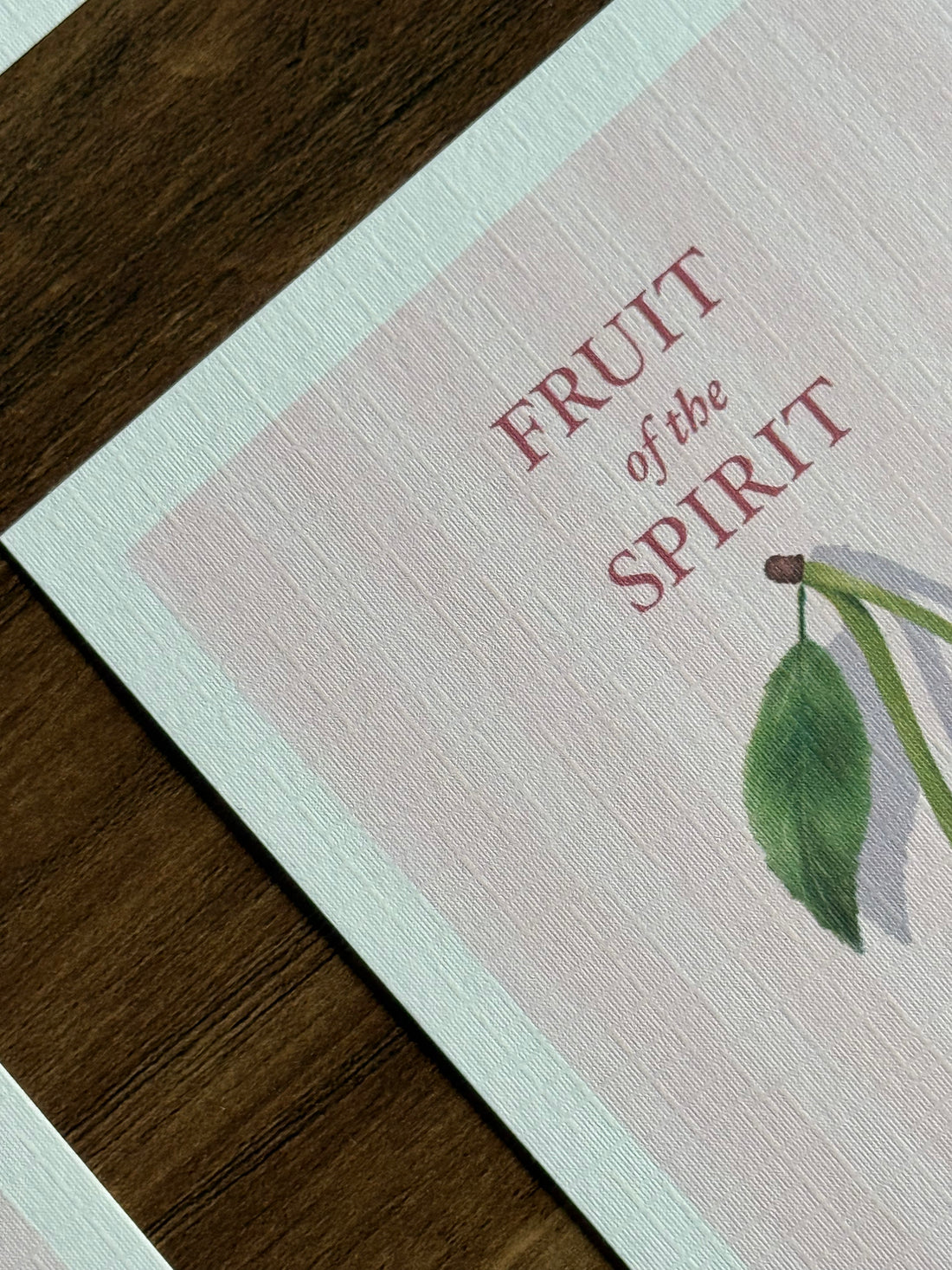 Fruit of the Spirit cards with cherries on a wooden surface